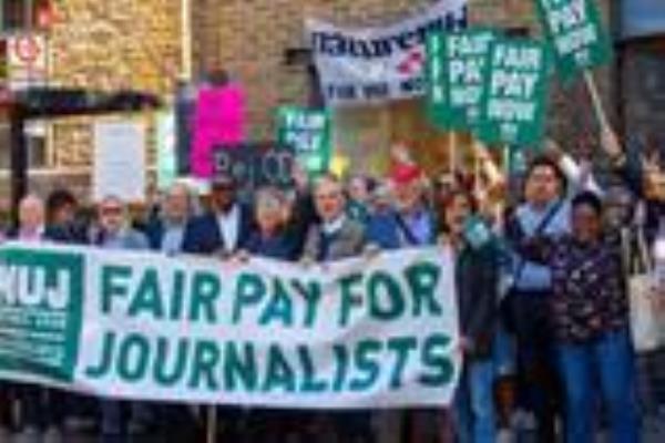 People protesting for fair pay on a picket line